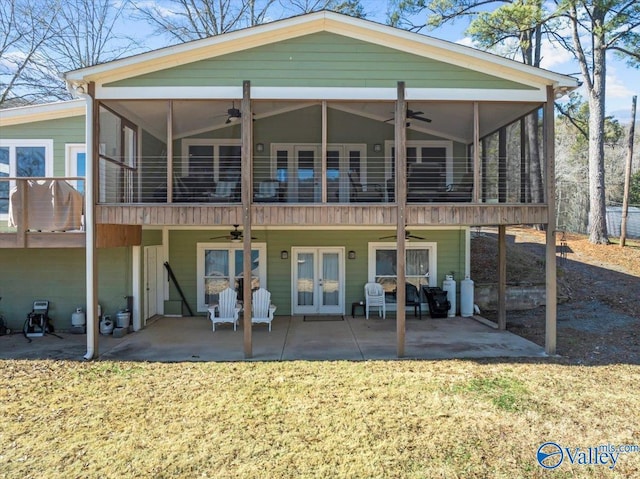 back of property with ceiling fan, french doors, a balcony, and a patio