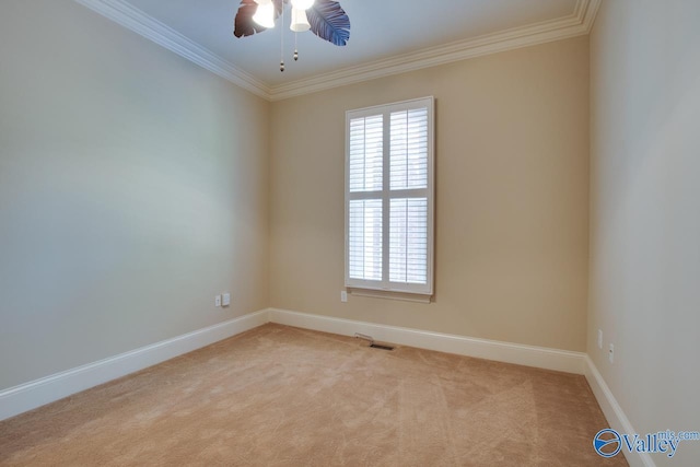 empty room featuring baseboards, ornamental molding, visible vents, and light colored carpet