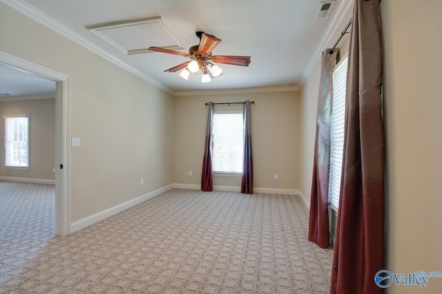 empty room featuring baseboards, ornamental molding, ceiling fan, and light colored carpet