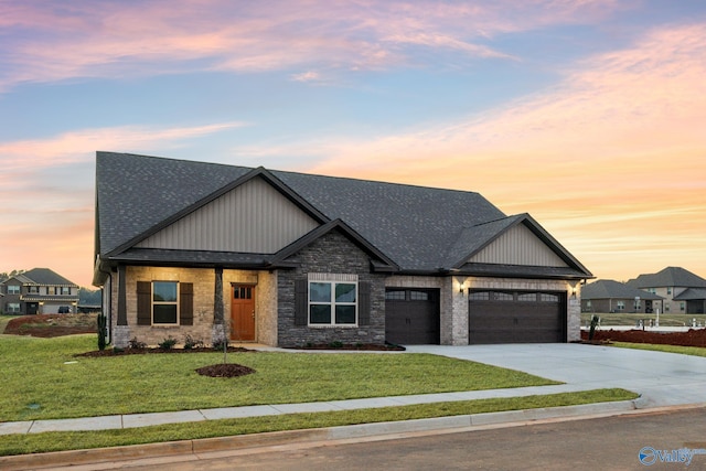 craftsman house with a lawn and a garage