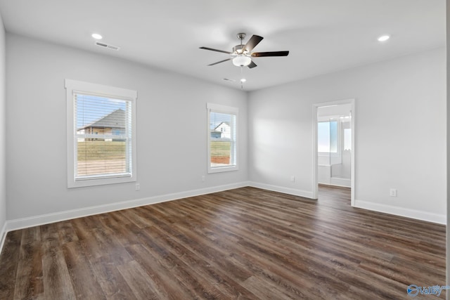 spare room with ceiling fan and dark hardwood / wood-style flooring