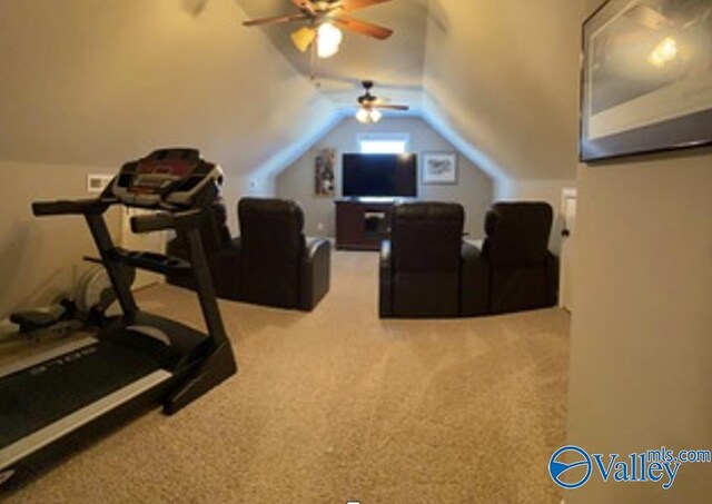 workout room featuring lofted ceiling, ceiling fan, and light colored carpet