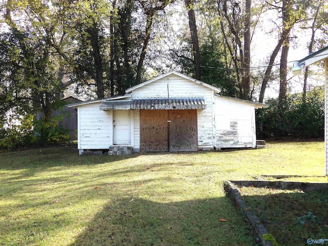 view of outbuilding with a lawn