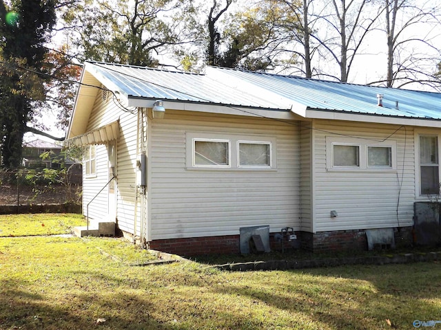 view of side of home with a yard