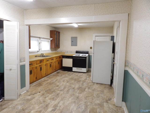 kitchen with white appliances, electric panel, and sink