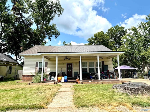 view of front of house featuring a front yard, a gazebo, and ceiling fan