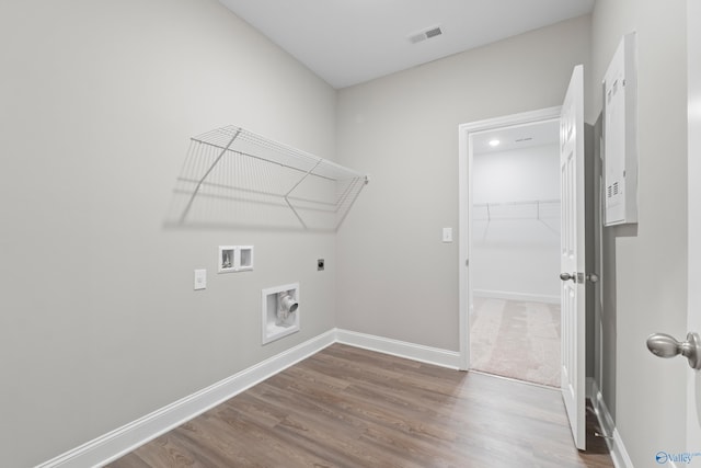 clothes washing area featuring washer hookup, wood-type flooring, and hookup for an electric dryer