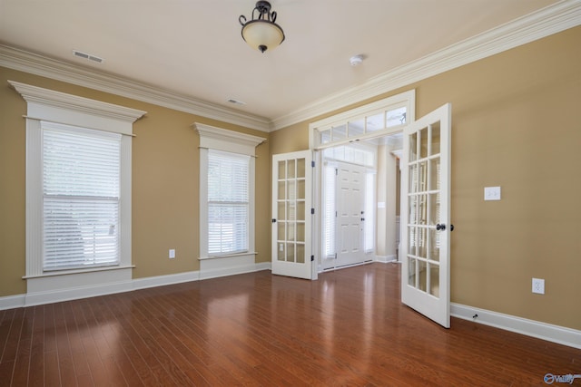 spare room featuring french doors, ornamental molding, and dark hardwood / wood-style flooring