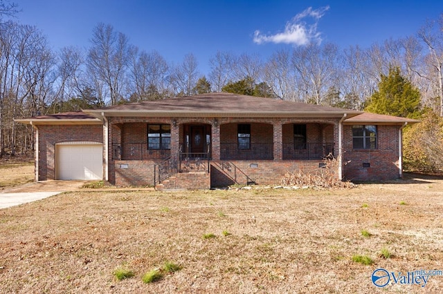 view of front of property featuring a garage, a front yard, and covered porch