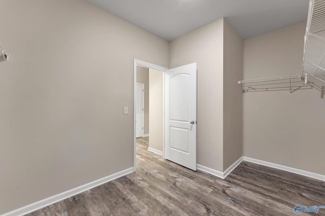 unfurnished bedroom featuring baseboards and wood finished floors