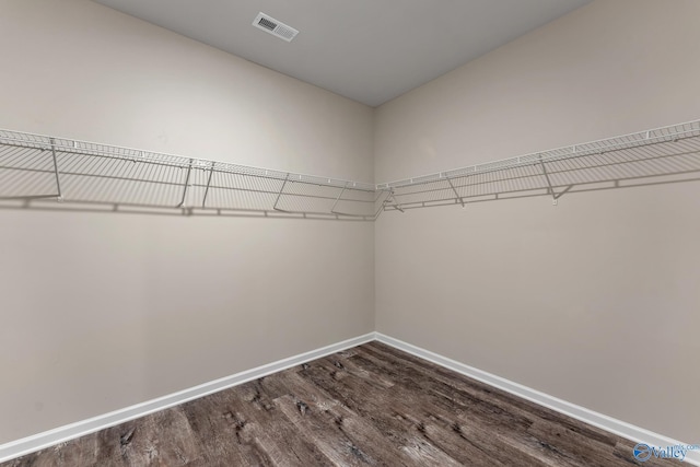 walk in closet with visible vents and wood finished floors