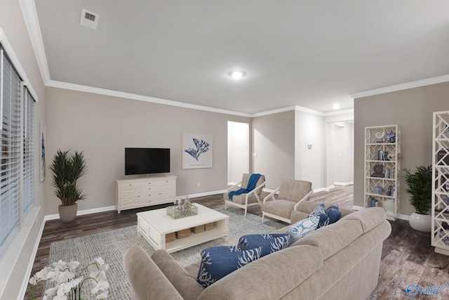 living room with visible vents, baseboards, and wood finished floors