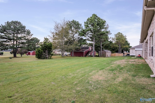 view of yard featuring an outbuilding and a shed