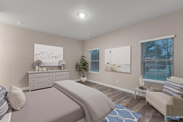 bedroom featuring baseboards and wood finished floors