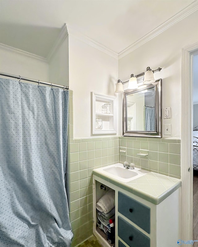 bathroom with crown molding, sink, and tile walls