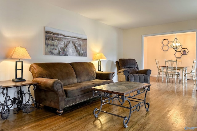 living room with wood-type flooring and a chandelier