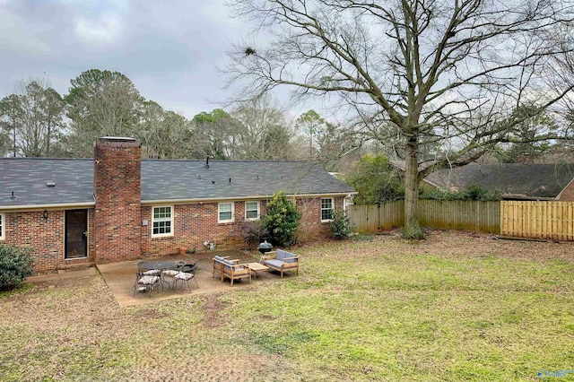 rear view of house with a patio and a lawn