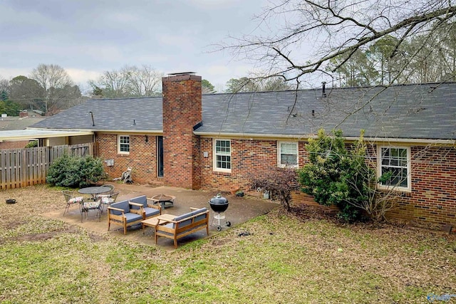 back of house featuring an outdoor living space, a yard, and a patio