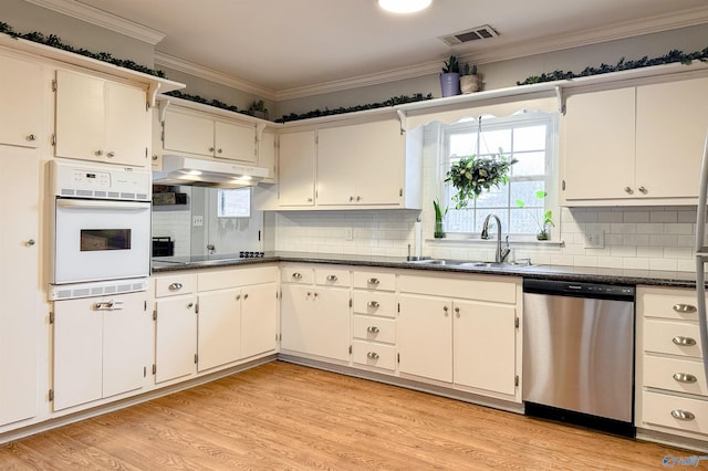 kitchen featuring sink, dishwasher, white oven, tasteful backsplash, and black electric stovetop