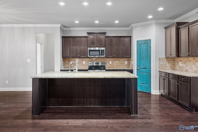 kitchen featuring appliances with stainless steel finishes, dark hardwood / wood-style flooring, dark brown cabinets, and sink