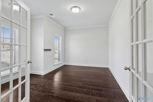 unfurnished room featuring crown molding, french doors, and dark wood-type flooring