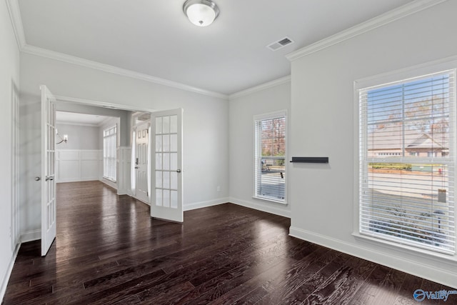 empty room with dark hardwood / wood-style flooring, french doors, and ornamental molding