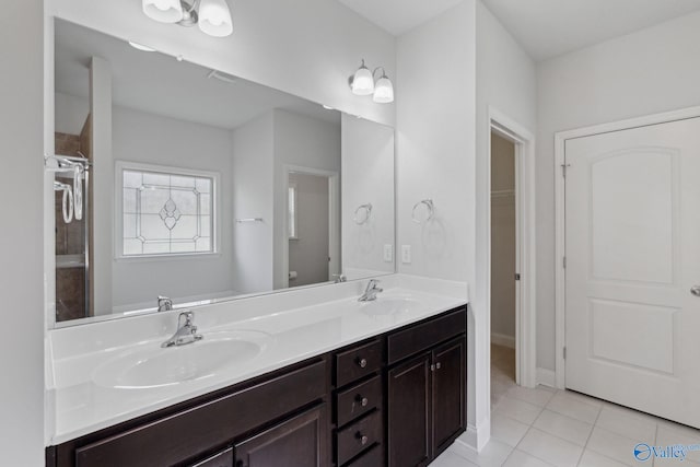 bathroom featuring tile patterned flooring, vanity, and toilet