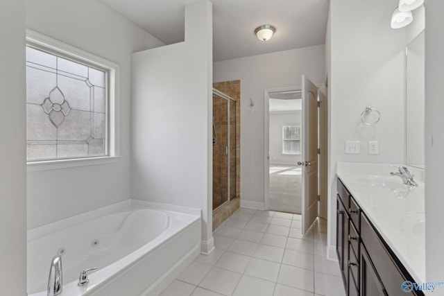 bathroom with tile patterned floors, plus walk in shower, vanity, and a healthy amount of sunlight