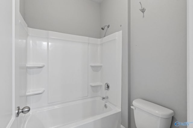 bathroom featuring shower / bathing tub combination and toilet