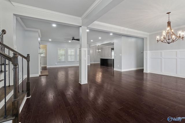 unfurnished living room with dark hardwood / wood-style floors, crown molding, and ceiling fan with notable chandelier