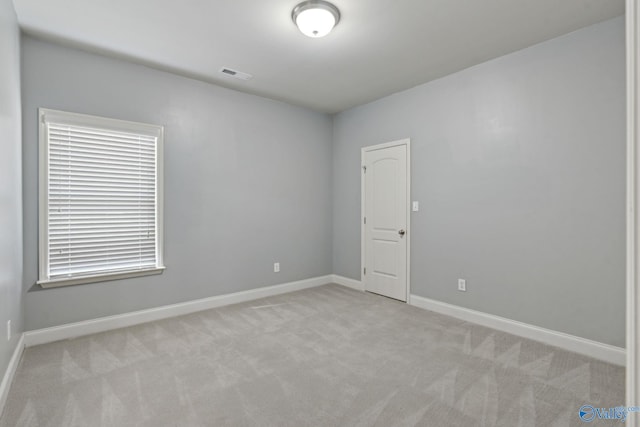 spare room with light carpet