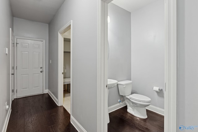 bathroom with hardwood / wood-style floors and toilet