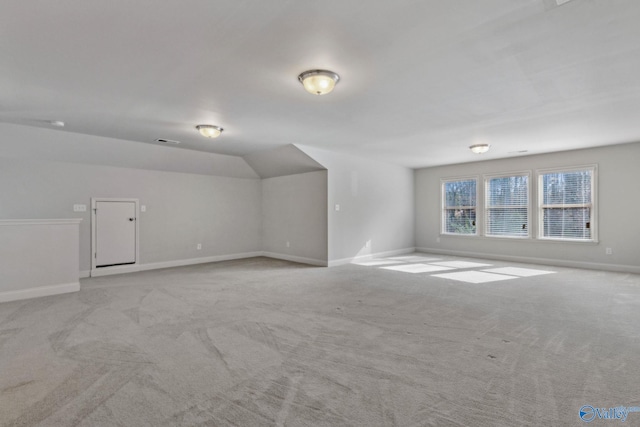 bonus room with light colored carpet