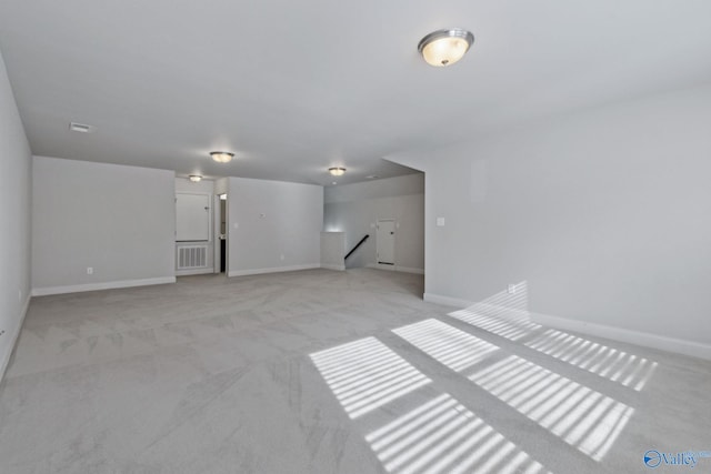 unfurnished room featuring light colored carpet