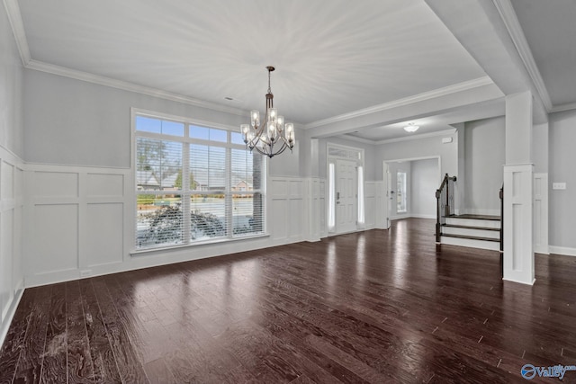 unfurnished dining area featuring a notable chandelier, dark hardwood / wood-style floors, and crown molding