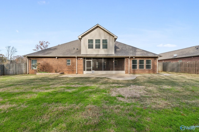 back of house with a patio, a sunroom, and a lawn