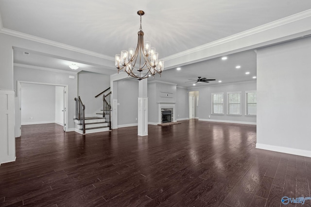 unfurnished living room with ceiling fan with notable chandelier, dark hardwood / wood-style flooring, and crown molding