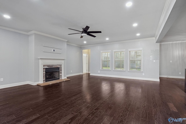 unfurnished living room featuring a fireplace, dark hardwood / wood-style floors, ceiling fan, and ornamental molding