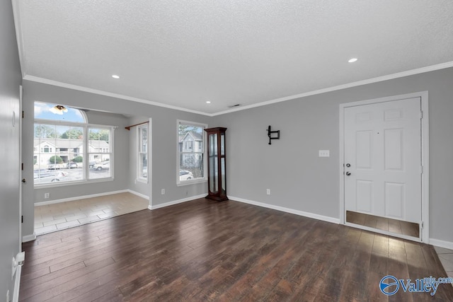 interior space with a textured ceiling, dark hardwood / wood-style flooring, and ornamental molding