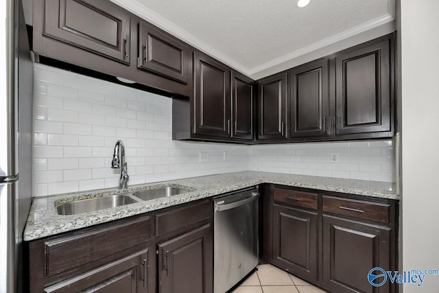 kitchen featuring crown molding, sink, a textured ceiling, light tile patterned flooring, and stainless steel appliances