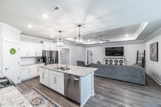 kitchen with ceiling fan, appliances with stainless steel finishes, a sink, visible vents, and ornamental molding