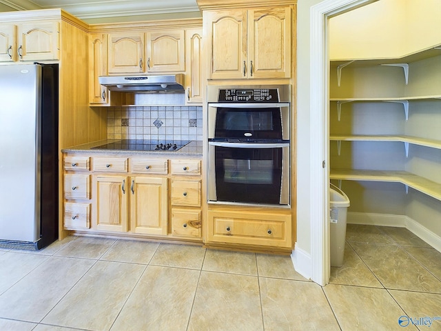 kitchen with stainless steel appliances, backsplash, light brown cabinetry, and light tile patterned floors