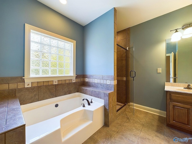 bathroom featuring tile patterned flooring, vanity, and plus walk in shower