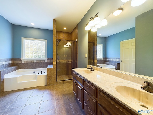 bathroom featuring tile walls, tile patterned floors, vanity, and separate shower and tub