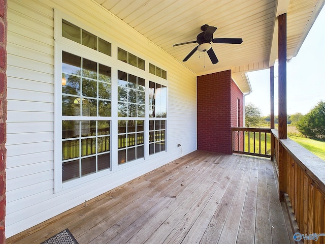 wooden terrace featuring ceiling fan