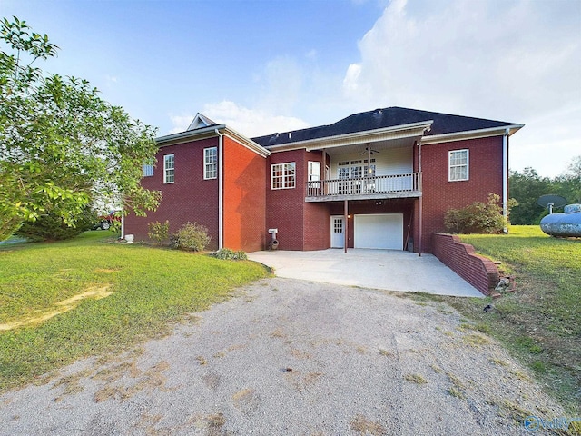 view of property featuring a garage and a front lawn