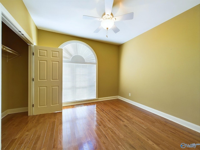 spare room featuring ceiling fan and hardwood / wood-style floors