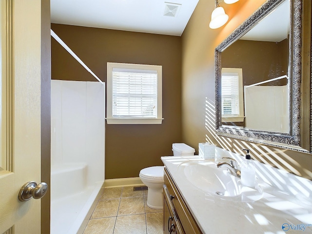 bathroom with walk in shower, vanity, toilet, and tile patterned floors