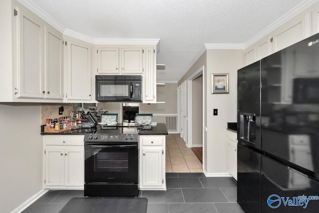 kitchen featuring dark tile patterned floors, white cabinetry, crown molding, black appliances, and a textured ceiling