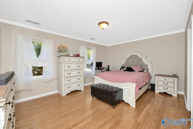 bedroom featuring ornamental molding and light hardwood / wood-style flooring